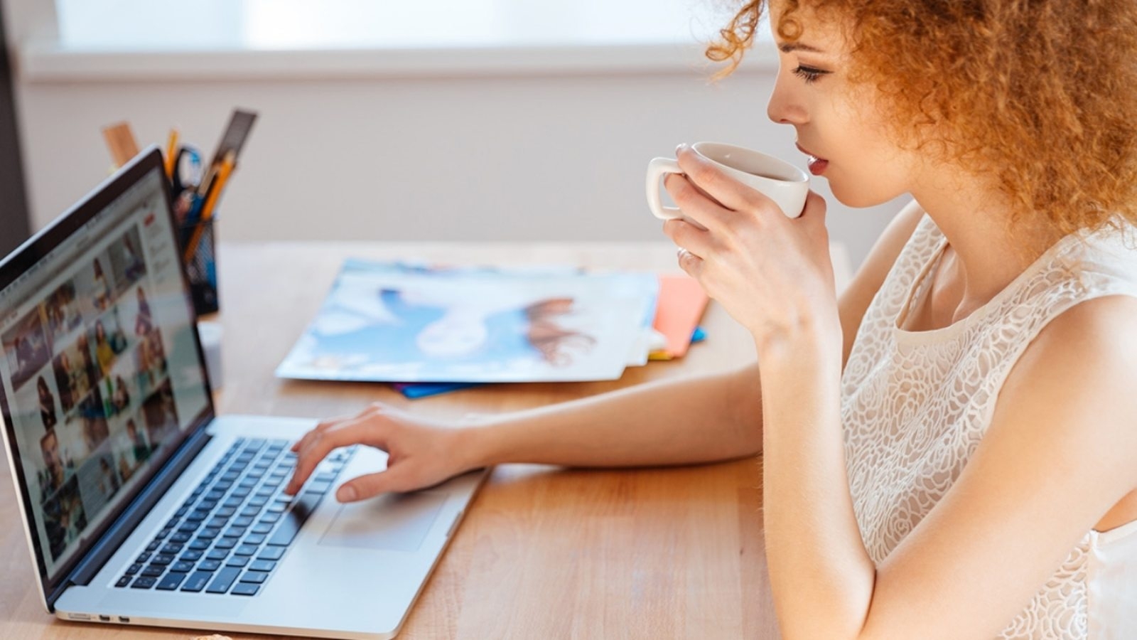 woman-photographer-drinking-coffee-and-working-PJNBP6U@2x-1600x900